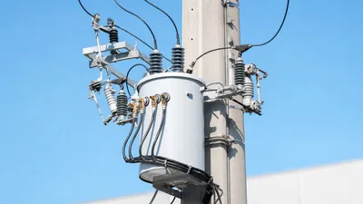 Heavy-duty 3 phase pole mounted transformer installed on utility pole with drop-out cutouts and surge arresters