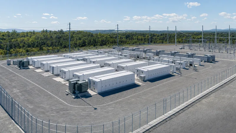 Aerial view of a utility-scale BESS location with containerised battery storage systems and grid substation