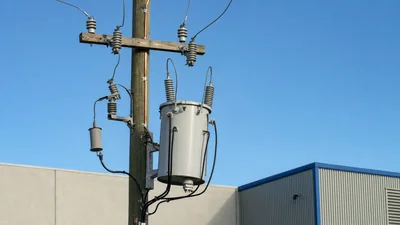 Pole transformer diagram layout showing overhead distribution transformer bushings, cutout fuse, and grounding.